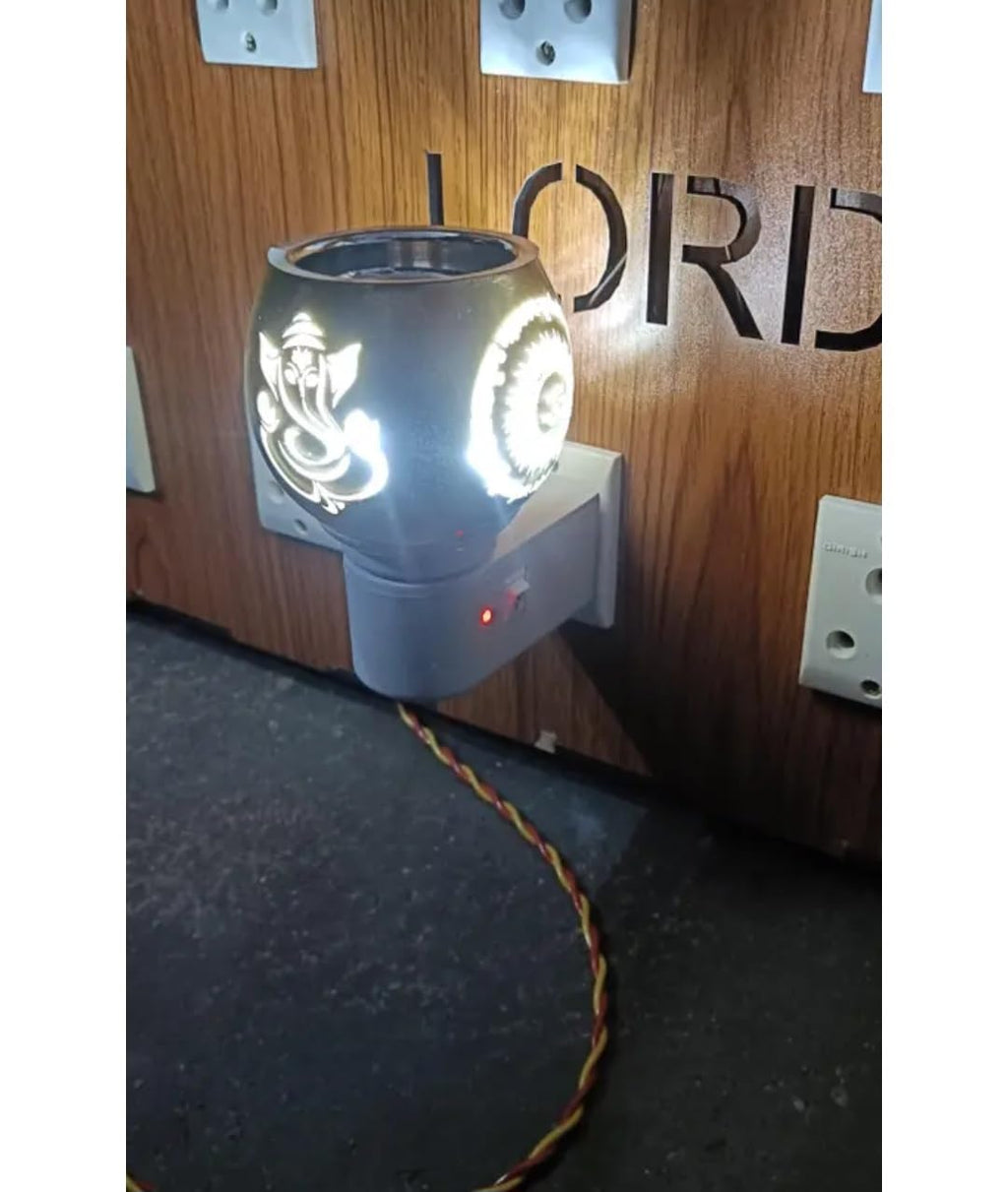 Electric Aroma Oil Diffuser Lamp with Ganesha and Om Design, Plug-in Night Light, Warm Golden Glow